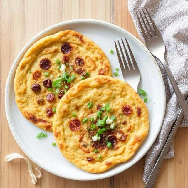 Chickpea flour pancakes (socca) served with fresh herbs and vegetables.