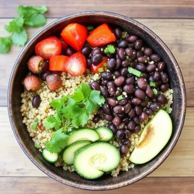 Hearty black bean and quinoa bowl with fresh vegetables and herbs.