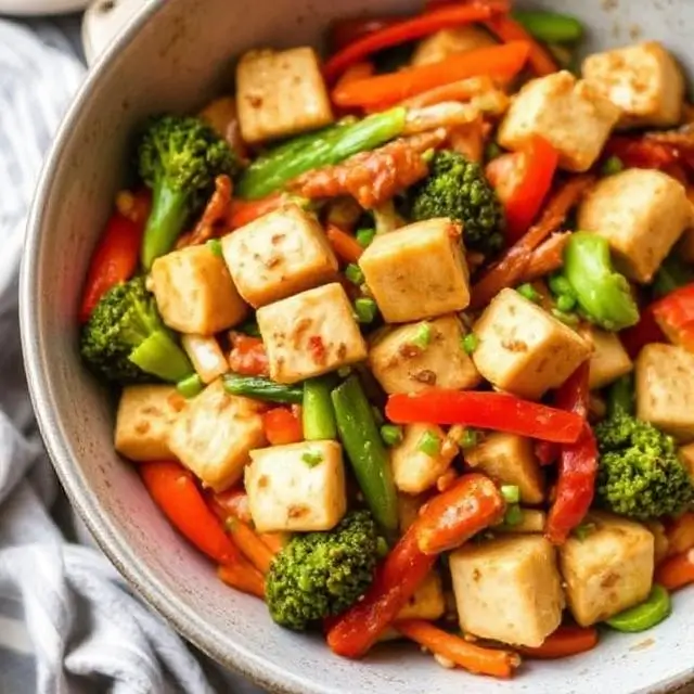 Quick tofu and veggie stir-fry in a skillet, with colorful vegetables and tofu pieces