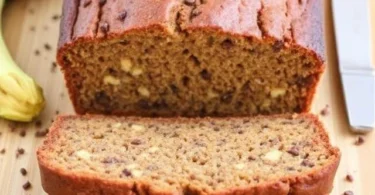 Healthy slices of protein zucchini bread arranged neatly, showing a moist interior with flecks of green zucchini and a golden crust.