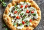 Golden-brown cottage cheese flatbread with a soft center, served on a wooden cutting board.