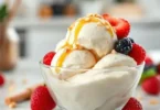 Homemade protein ice cream in a white bowl topped with fresh berries and almonds, healthy high-protein dessert.